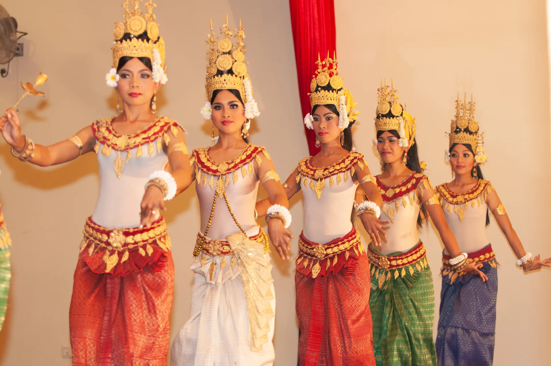 Apsara dancers in gold headdresses and traditional costume performing in Siem Reap